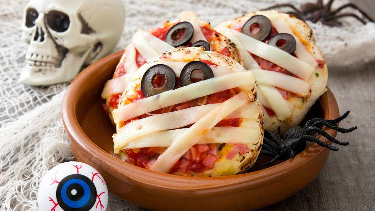 Image of mini pizzas with ham, olives and cheese to look on a mummy