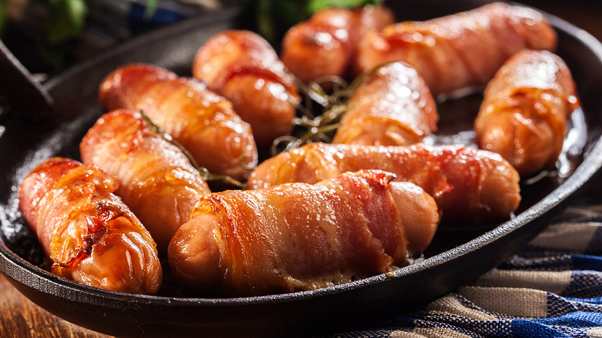 Image of pork sausages wrapped in crispy bacon