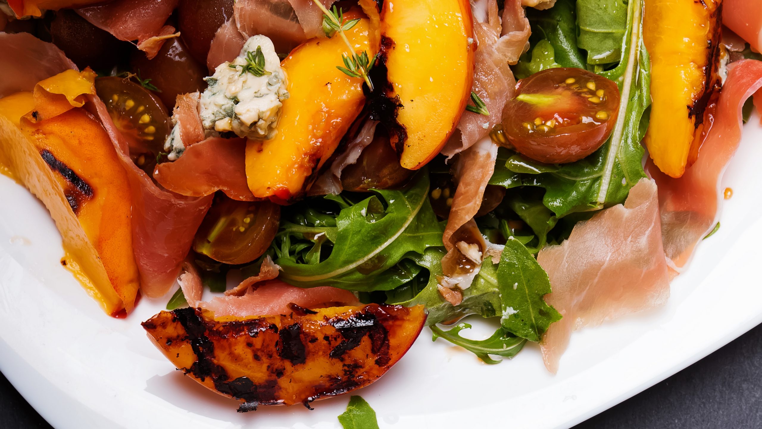 Grilled prosciutto-wrapped peaches